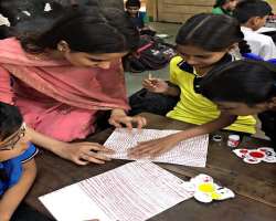 She teaches the skills of painting to the little children and loves to spend time with them.